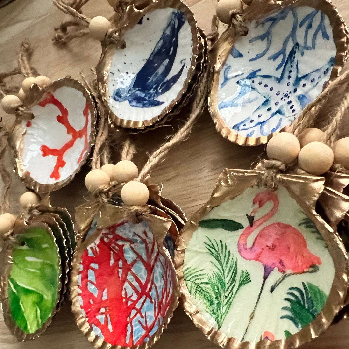 Decorative shell ornaments with colorful designs on a wooden surface